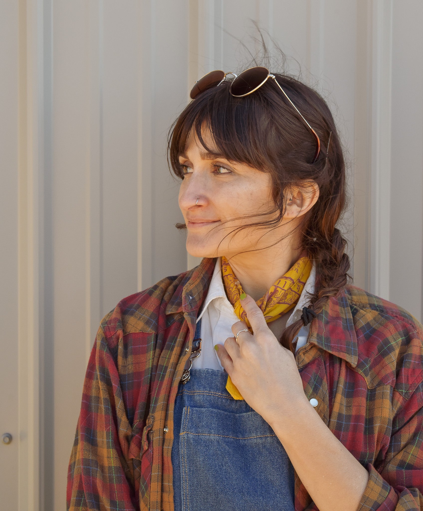 Model adjusting collar while posing with the sterling silver bit ring for Saddle & Stone